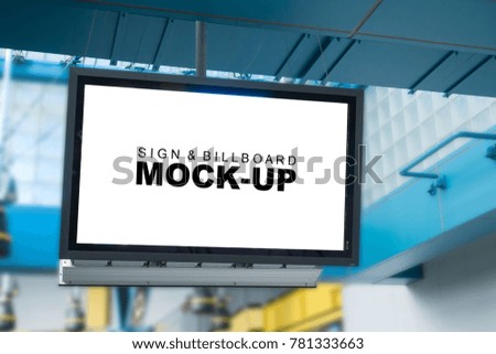 Selective focus at mock up blank billboard hanging on ceiling for information or advertisement on display with clipping path, blurred beautiful building on background