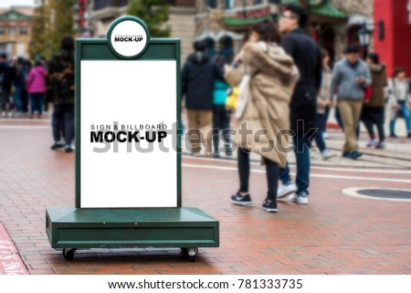 The mock up blank white screen of green circle and vertical billboard on scroll wheel in city street, display for public information at front of shop, people walking around there, with clipping path