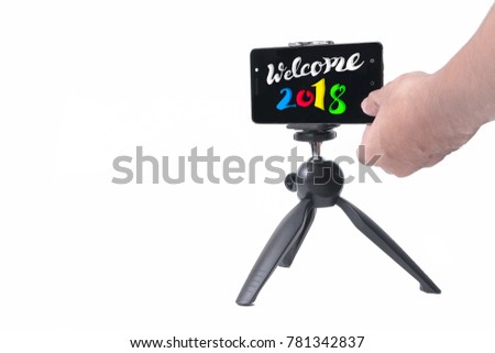 welcome 2018 quote with smartphone on the tripod with a finger ready to type text background.
