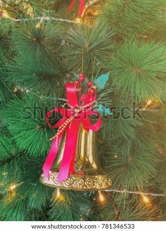 Christmas tree decorated with bells and a star.