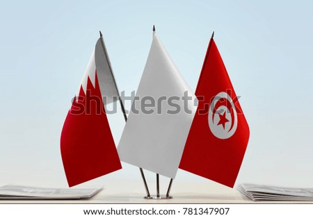 Flags of Bahrain and Tunisia with a white flag in the middle