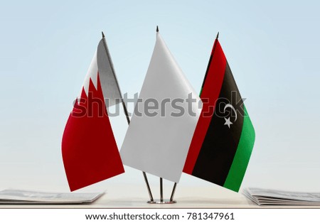 Flags of Bahrain and Libya with a white flag in the middle