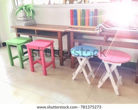 The coffee shop has a colorful wooden chairs.