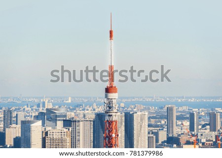 Asia Business concept for real estate and corporate construction - modern city skyline bird eye aerial close up view of Tokyo Tower under bright sun and vivid blue sky in Roppongi Hill, Tokyo, Japan