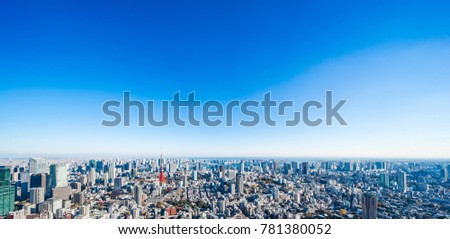 Asia Business concept for real estate and corporate construction - panoramic modern city skyline bird eye aerial view of tokyo tower under bright sun and vivid blue sky in Roppongi Hill, Tokyo, Japan