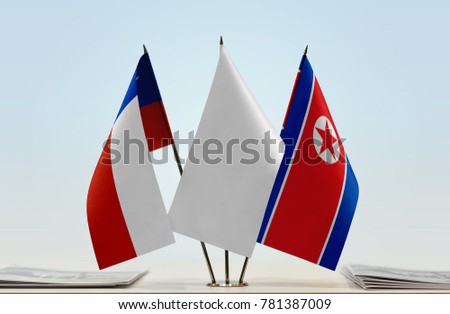 Flags of Chile and North Korea with a white flag in the middle