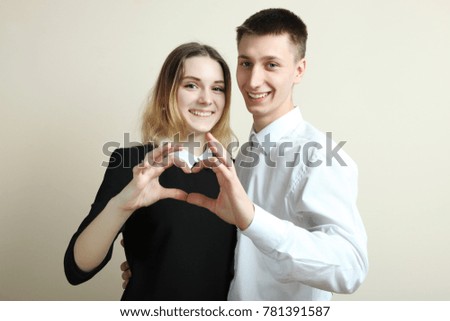 Young couple in love, guy and girl on a neutral background.