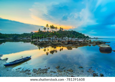 
Beauty sunset and boat fishermen village bintan island Royalty-Free Stock Photo #781391608