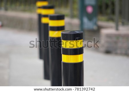 Yellow and black poles road blocker