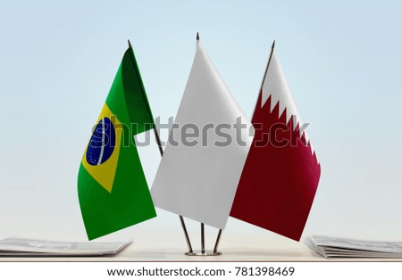 Flags of Brazil and Qatar with a white flag in the middle