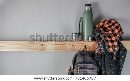 Travel accessories set on wooden shelf and gray background for your text