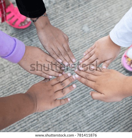 Asian child's make hand sign as which stay together.