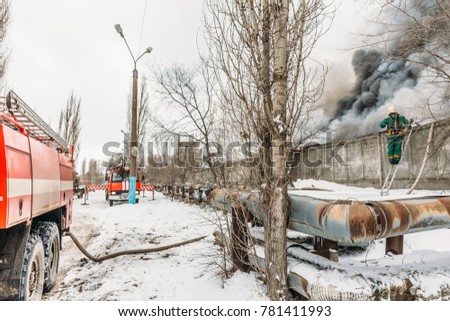 Fire in an industrial warehouse on Lantenskaya Street, rubber is burning, lots of smoke and flames, firefighters and MES rescue workers are struggling with a fire