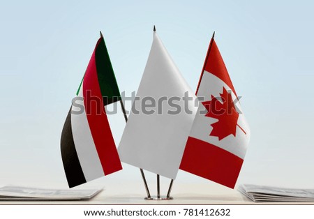 Flags of Sudan and Canada with a white flag in the middle