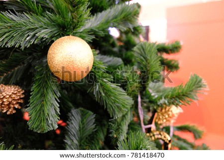 Golden ball and ornaments of Christmas are hanging on Christmas tree with space for your text design,decorate for Christmas and Happy New Year festival. Blur picture and vintage style.