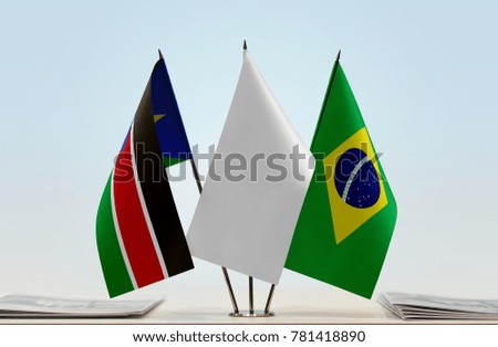 Flags of South Sudan and Brazil with a white flag in the middle