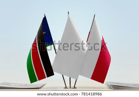 Flags of South Sudan and Poland with a white flag in the middle
