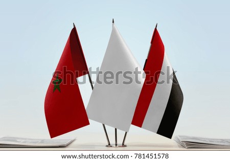 Flags of Morocco and Yemen with a white flag in the middle