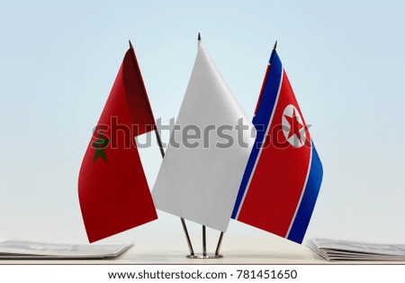 Flags of Morocco and North Korea with a white flag in the middle