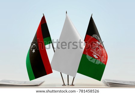 Flags of Libya and Afghanistan with a white flag in the middle