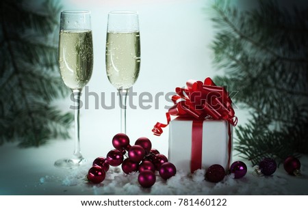 two glasses with champagne, and boxes with gifts on Christmas b