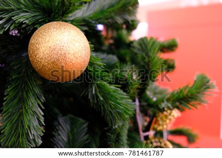 Golden ball and ornaments of Christmas are hanging on Christmas tree with space for your text design,decorate for Christmas and Happy New Year festival. Blur picture and vintage style.