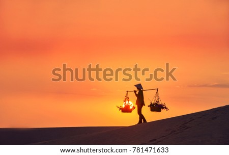 woman with Vietnam culture traditional dress on sandune during sunset ,traditional costume ,Muine Vietnam Royalty-Free Stock Photo #781471633
