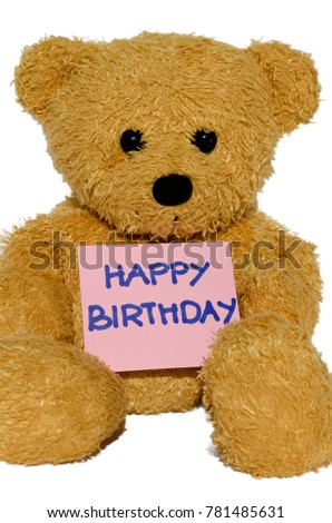 Cute brown plush teddy bear holding a pink card saying Happy Birthday. image is with an isolated white background.