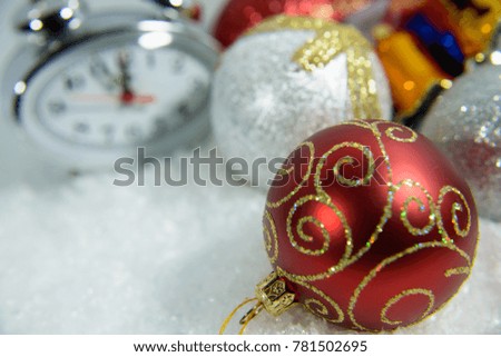 New Year Clock lie in brightly colored shiny tinsel