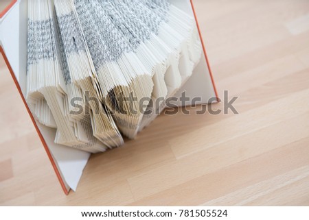 Book pages folded into the word Home