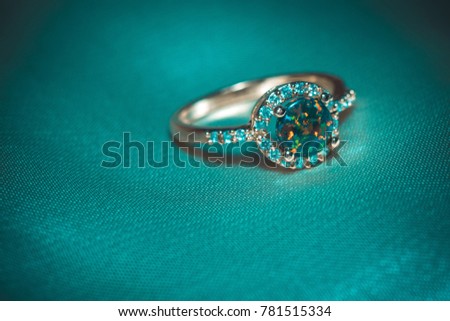 Fashion golden ring with synthetic fire opal stone of green color.