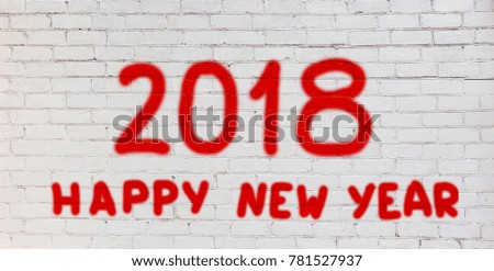 Happy new year 2018. Graffiti with red lettering Happy new year 2018 on a white brick wall. Wide screen greeting Web banner