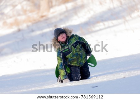 Portrait of a boy on the background of a winter snowy landscape.