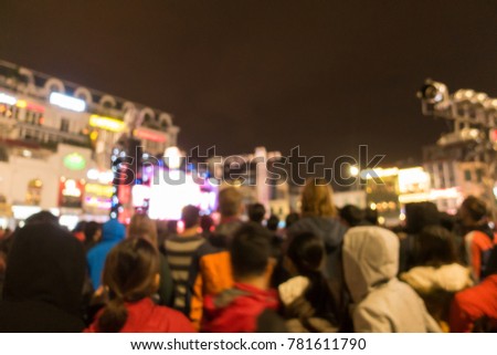 Hanoi-December,2017: Royalty high quality free stock image of blurred background: Bokeh lighting and people at music show outdoor on street. Outdoor stage is crowded in night