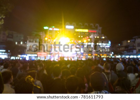 Hanoi-December,2017: Royalty high quality free stock image of blurred background: Bokeh lighting and people at music show outdoor on street. Outdoor stage is crowded in night
