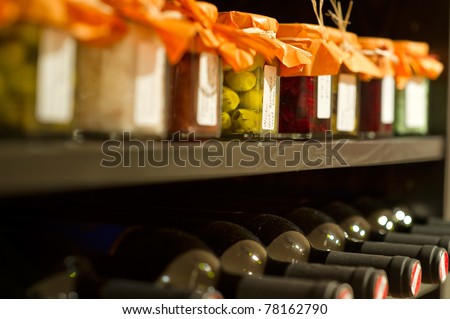 Wine bottles and mason jars in a shelf
