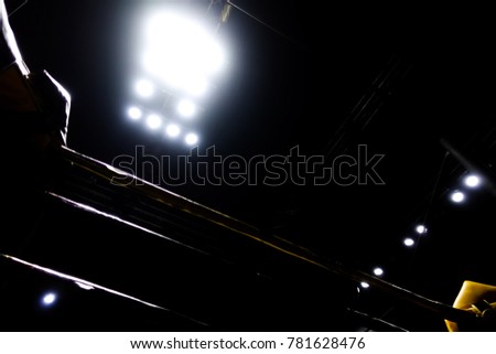 The silhouette of the boxing ring in the dark with the light.