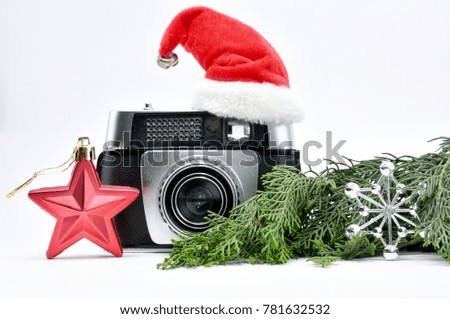 Vintage camera surrounded by Christmas toys, Santa's Christmas tree and caps.For Isolation.