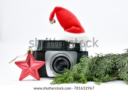 Vintage camera surrounded by Christmas toys, Santa's Christmas tree and caps.For Isolation.