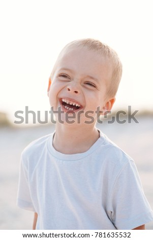 Portrait of smiling todler boy outdoor, on the beach