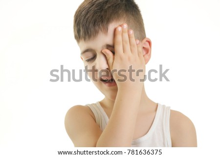 Studio shot of young boy with eye pain. Can not see you concept.