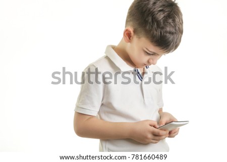 
Studio shot of little boy with smart phone, kids cell phones addiction concept