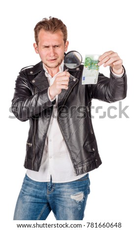 man looking in magnifying glass on a euro banknote