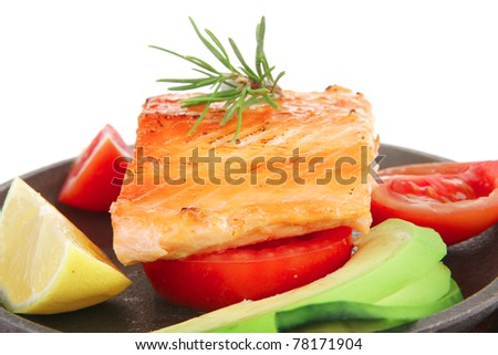 food: hot baked salmon piece served on iron pan over wooden plate isolated on white background