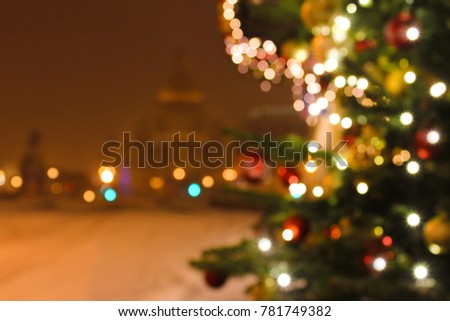 Festive Christmas Christmas blurred background, bokeh, Christmas tree lights and the outlines of St. Isaac's Cathedral in St. Petersburg on a winter night is the background for the text of the article