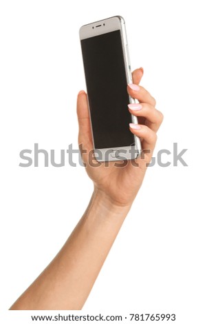 Side view of beautiful relaxed left human female hand with neutral manicure hold blank screen smartphone in a palm isolated on abstract blurred white background. Detailed closeup studio shot