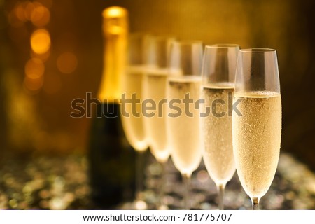 Many glasses of champagne in a line. Selective focus. Vintage tone Royalty-Free Stock Photo #781775707