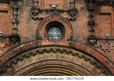 Oval window on weathered wall of church