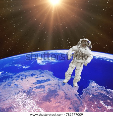 Sunlight over the earth and astronaut in outer space. The elements of this image furnished by NASA.
