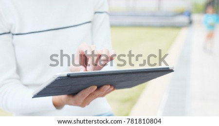 Woman use of tablet at outdoor 